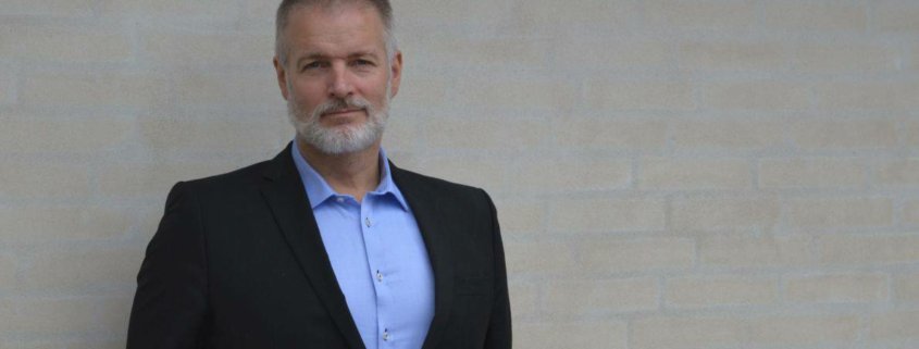 Mand i blå skjorte og sort blazer - lederskab